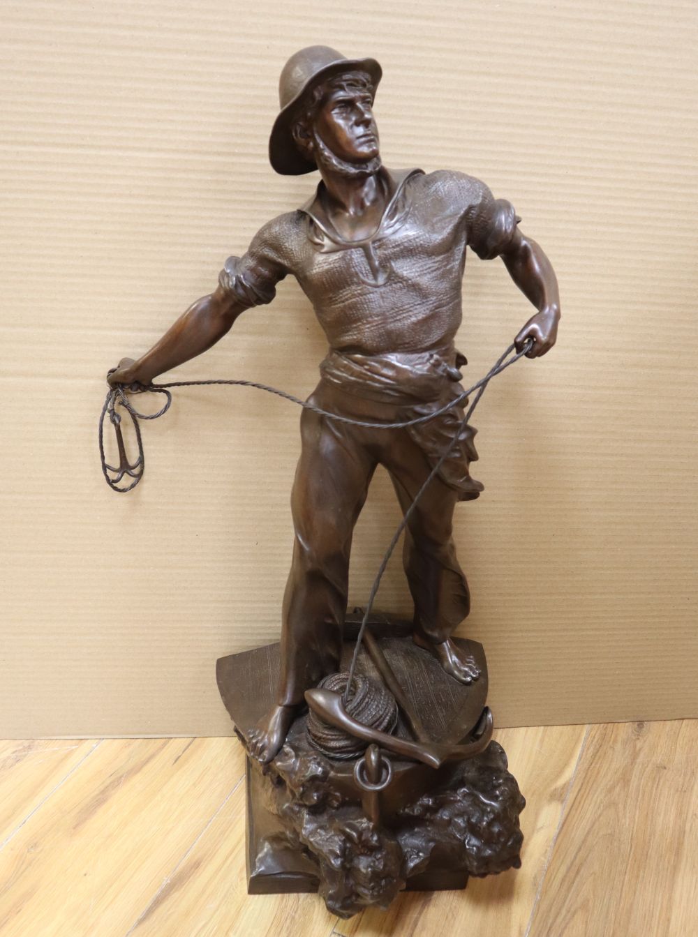 After Waagen Sept. A bronzed spelter model of a fishermen Secours, signed, 72cm